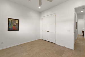 Unfurnished bedroom with a closet, recessed lighting, ceiling fan, and light tile patterned floors