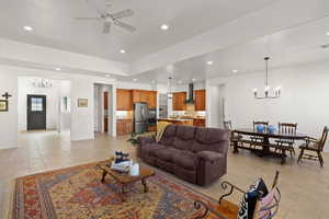 Living area featuring a chandelier, recessed lighting, and a ceiling fan