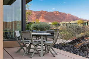 View of patio with outdoor dining space and a mountain view