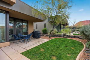 View of green lawn with a patio, a mountain view, and outdoor dining space