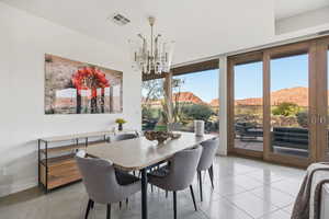 Dining area featuring a mountain view, a chandelier, and light tile patterned floors