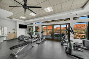 Gym featuring a paneled ceiling and ceiling fan