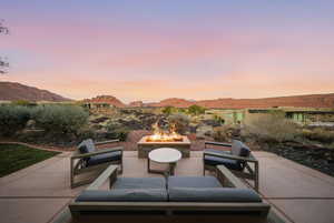 View of patio with an outdoor living space with a fire pit and a mountain view