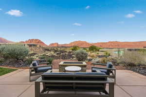 View of patio / terrace with a mountain view and an outdoor living space with a fire pit