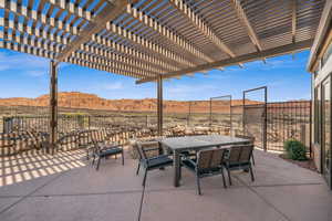 View of patio with outdoor dining space, a mountain view, and a pergola