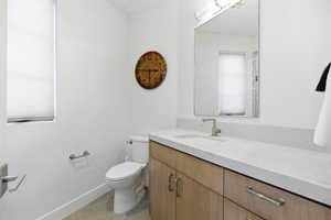 Half bath with vanity and toilet