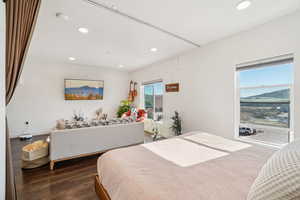 Bedroom featuring wood finished floors, recessed lighting, and a mountain view
