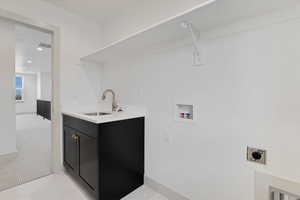 Laundry room with washer hookup, electric dryer hookup, light carpet, recessed lighting, and cabinet space