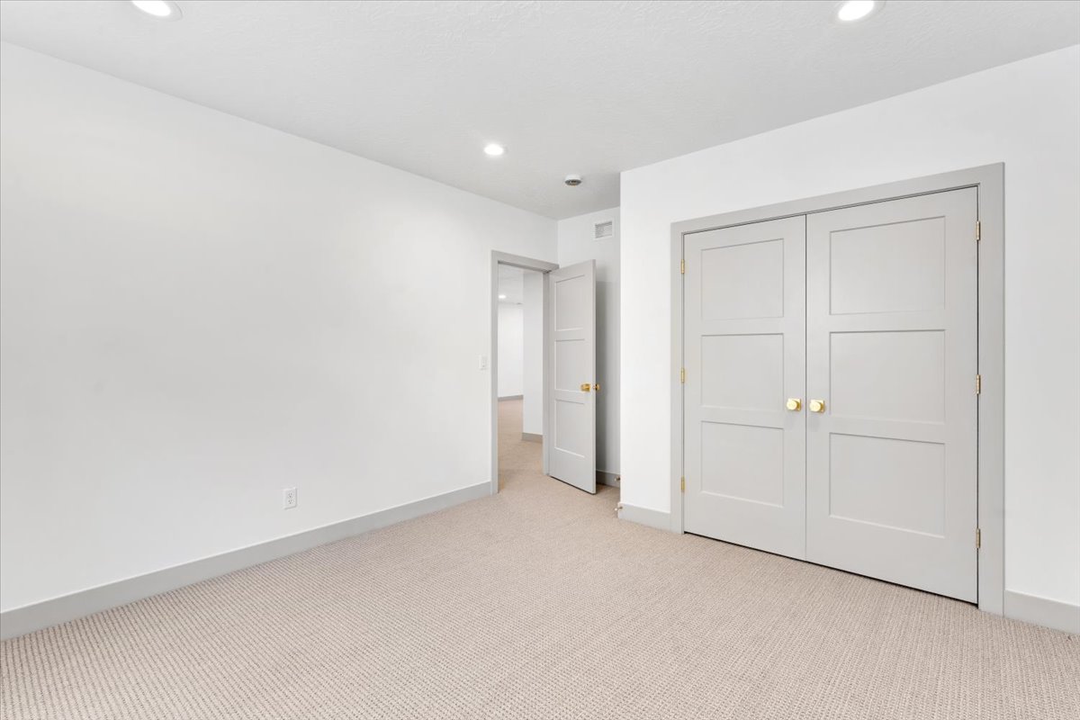 Light-colored carpeting complementing white walls and grey baseboards