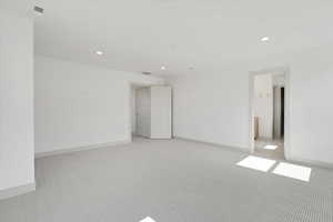 Spare room with light carpet and recessed lighting