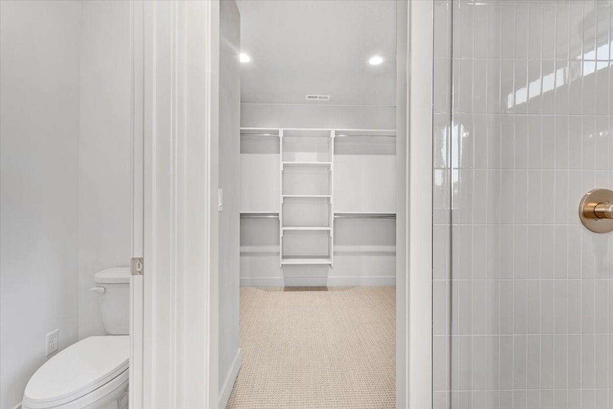 Walk-in closet with carpet flooring, recessed lighting, and built-in shelving