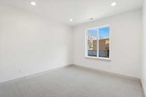 Spare room with carpet and recessed lighting