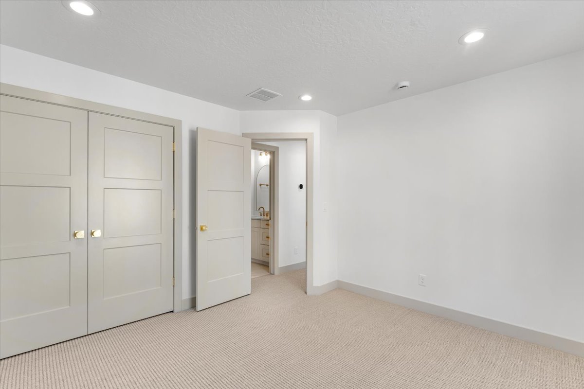 Room featuring light-colored carpeting, white walls, and recessed lighting