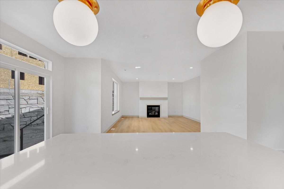 Expansive white countertop with a sliding glass door and transom window, offering abundant natural light