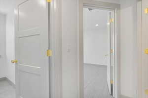 Hall with baseboards and recessed lighting