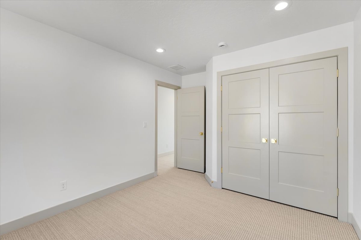 Neutral-toned carpeting paired with light gray walls and trim