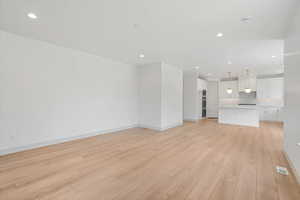 Unfurnished living room with light wood-style floors and recessed lighting
