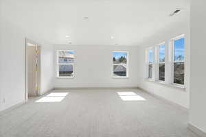 Unfurnished room with light carpet and recessed lighting
