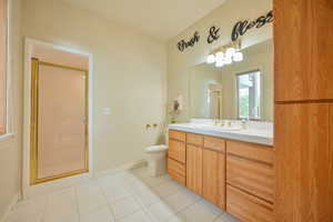 Bathroom with a stall shower, vanity, and light tile patterned floors