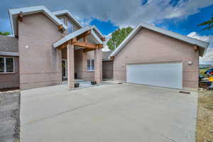 View of front facade featuring brick siding and driveway
