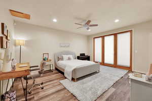 Bedroom with an office area, access to outside, light wood finished floors, a ceiling fan, and recessed lighting
