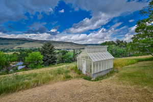 View of greenhouse featuring a mountain view and a view of countryside