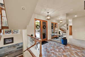 Foyer entrance featuring stairway, french doors, and stone finish floors