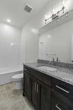 Full bathroom with vanity, shower / bathtub combination, and light tile patterned floors