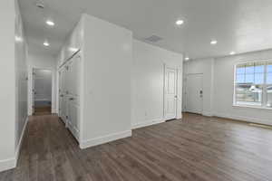 Unfurnished room with dark wood-type flooring and recessed lighting