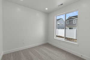 Carpeted spare room with recessed lighting