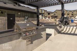 View of patio / terrace with area for grilling and a pergola