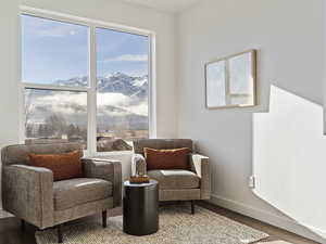 Sitting room with wood finished floors and a mountain view