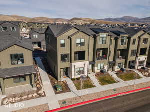 View of front of house with board and batten siding, a residential view, and a mountain view