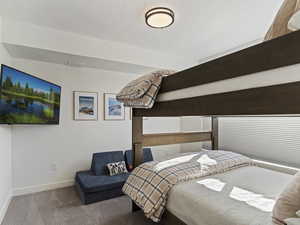 Bedroom with carpet and a textured ceiling