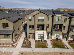 View of front facade featuring board and batten siding, a residential view, and stone siding