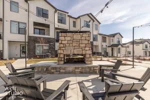 View of patio / terrace with an outdoor stone fireplace and a residential view