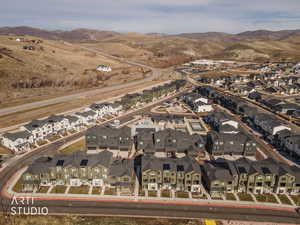 Aerial overview of property's location featuring nearby suburban area and mountains