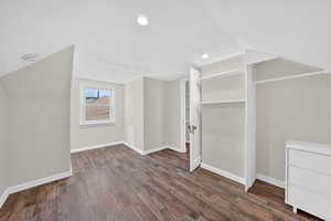 Bonus room featuring lofted ceiling and dark wood-style floors