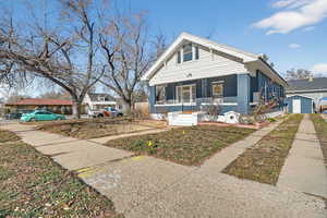 Bungalow-style house with covered porch and brick siding
