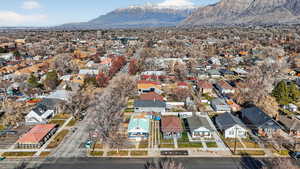 Aerial view of property's location featuring a mountainous background and nearby suburban area
