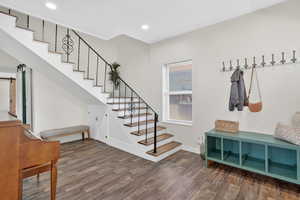 Mudroom featuring wood finished floors, a barn door, and recessed lighting