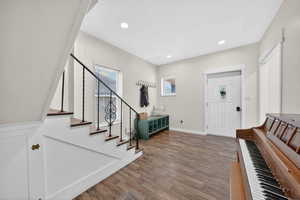 Entrance foyer featuring dark wood finished floors, recessed lighting, and stairway