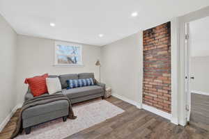 Sitting room with wood finished floors and recessed lighting