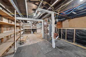 Unfinished basement featuring water heater
