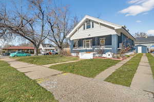Bungalow-style home featuring a porch and a front yard
