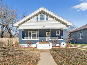 View of front of home with a porch and a front lawn