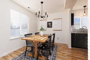 Dining room featuring a chandelier, light wood finished floors, and healthy amount of natural light