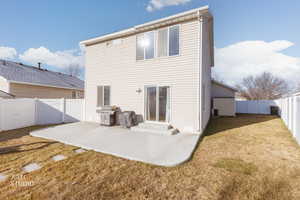 Back of property with a patio, a fenced backyard, and entry steps