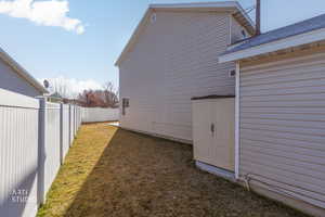 View of side of property with a fenced backyard