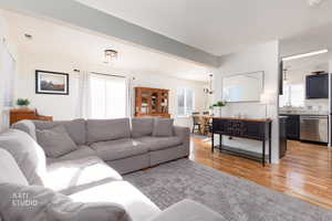 Living area featuring light wood-style flooring and a chandelier